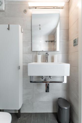 a bathroom with a white sink and a mirror at Aegeas Secret in Naxos Chora