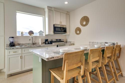 a kitchen with a large island with bar stools at WFH-Friendly Brownsville Home with Private Patio in Brownsville