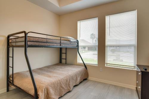 a bedroom with a bunk bed and two windows at Brownsville Home 8 Mi to Gladys Porter Zoo in Brownsville