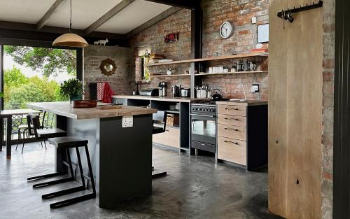 a kitchen with a counter and a brick wall at Brickhouse in Monteray