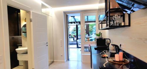 a kitchen with a black counter top and a hallway at Apart-terrace on Baker Street in Lviv