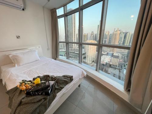 a bedroom with a bed and a large window at ThePenthouse Coliving I in Dubai