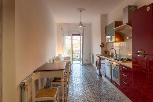 a kitchen with a table and a counter top at Orchidee apartment in Rieti