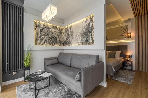 a living room with a couch and a bed at Q18 ApartHotel in Bydgoszcz