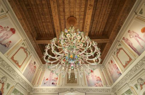 a large chandelier hanging from the ceiling of a building at Byblos Art Hotel Villa Amistà in San Pietro in Cariano