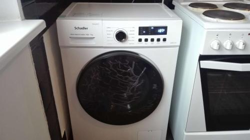 a white washing machine next to a white stove at Anni Apartment in Tallinn