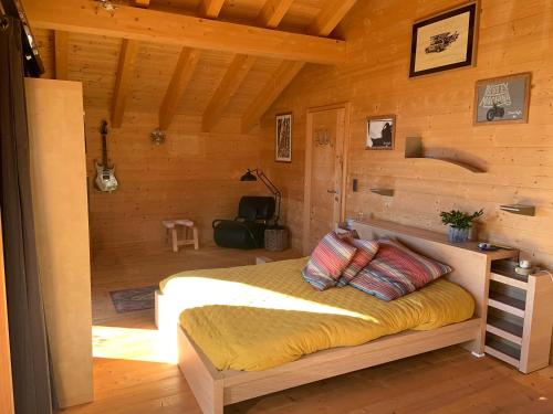 a bedroom with a bed in a wooden cabin at Les hirondelles in Ollon