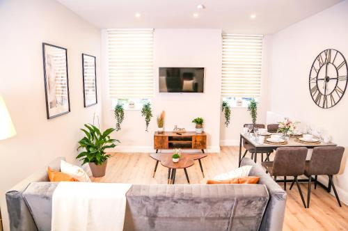a living room with a couch and a table at Shrewsbury apartments by BEVOLVE - Free Parking in Shrewsbury