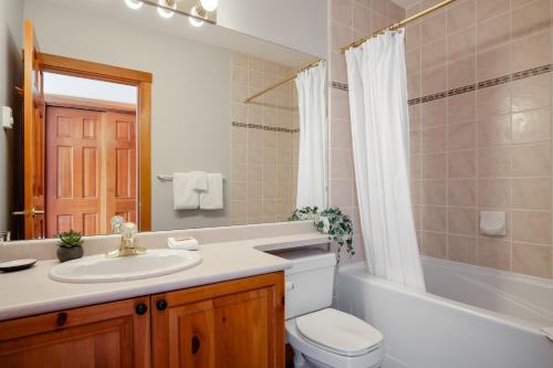 a bathroom with a sink and a toilet and a tub at 2BR Very Spacious Townhome in a Great Location by Harmony Whistler in Whistler