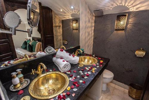 a bathroom with two sinks and towels on a counter at Palais Nazha Fes - Luxury Lodging in Fès