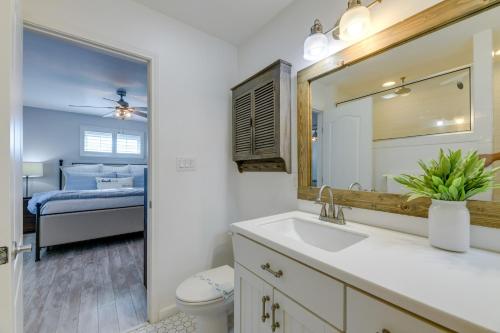 a bathroom with a sink and a mirror and a bed at Trendy Beach House with Private Pool and Deck! in Port Aransas