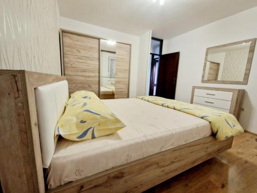 a bedroom with a bed with yellow and blue pillows at Esperanto in Vranje