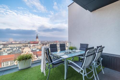 a table and chairs on a balcony with a view at Q18 ApartHotel in Bydgoszcz