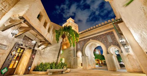 a building with a palm tree in front of it at Palais Nazha Fes - Luxury Lodging in Fès