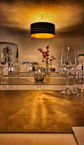 a kitchen with a counter with glasses and a light at Hotel Lekker in Neumagen-Dhron