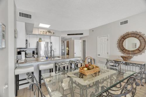 a kitchen with a table with a bowl of fruit on it at Three-Bedroom Apartment in Orange Beach