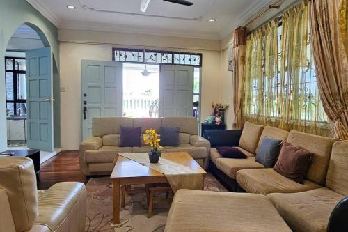 a living room with couches and a table at Kenyalang Piasau Homestay in Miri