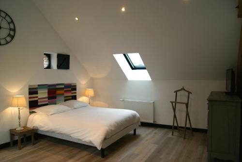a bedroom with a bed and a skylight at La Grange De Salomé in Salomé