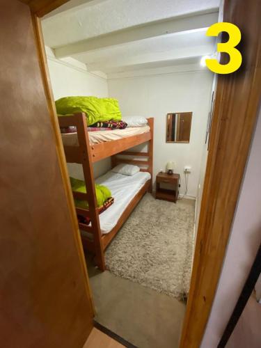 a room with two bunk beds in a room at Departamentos Puerto Montt in Puerto Montt