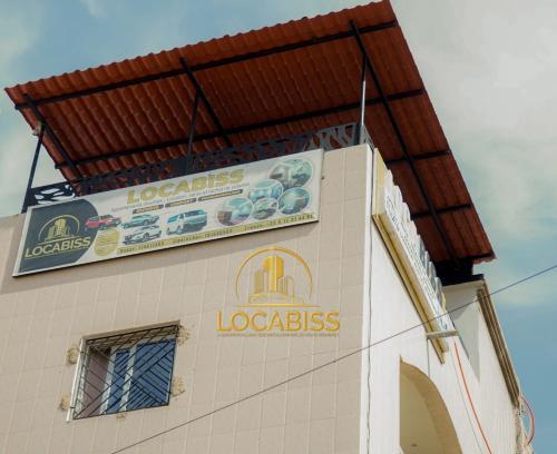 a sign on the side of a building at LOCABISS 3-Madina in Rufisque