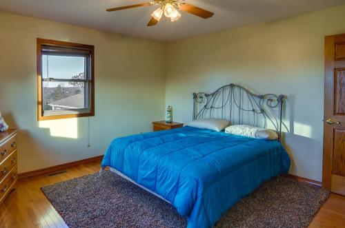 a bedroom with a blue bed and a ceiling fan at Byrdstown Apartment Less Than 4 Mi to Dale Hollow Lake! in Frogue