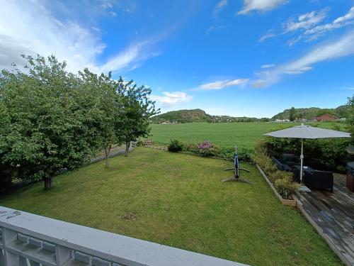 a view of a yard with an umbrella at Mikael's Bed & Spa in Sandefjord