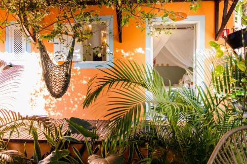 a bunch of plants in front of a building at Vila Charme in Jericoacoara