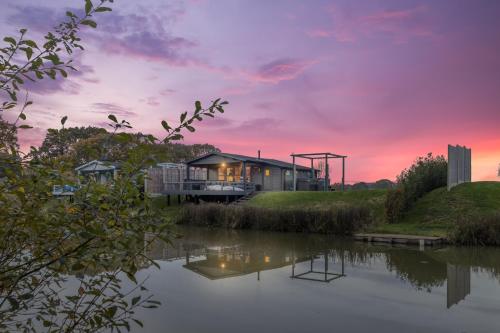 a house on a hill next to a river at Nestledstays- Sunbeam in Arundel