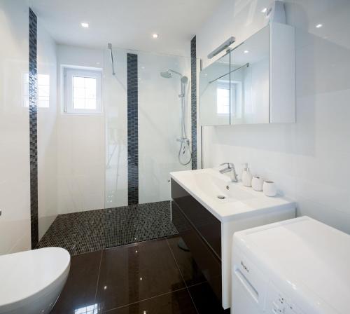 a white bathroom with a sink and a shower at Superior Apartment CASA SPALATO in Split