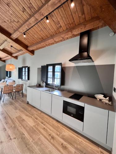 a kitchen with white cabinets and a stove top oven at Aldea Rural y Gastro Restaurante Casona de Labrada in Labrada