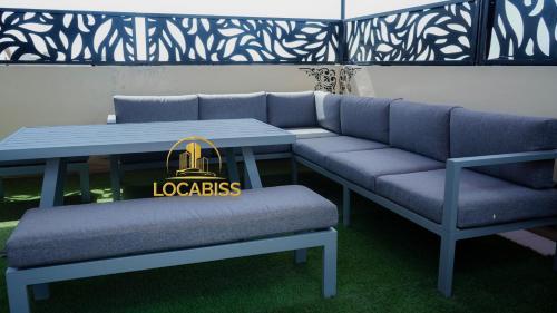 a table and bench with a louisbourg bag on it at LOCABISS 3-Madina in Rufisque