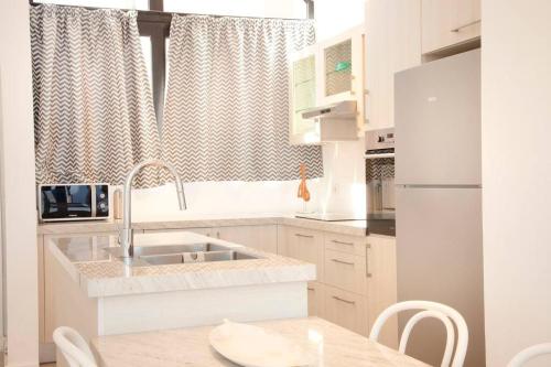 a kitchen with a sink and a counter top at Modern Soma Bay 2BR Villa w sea views, beach & pool access in Hurghada