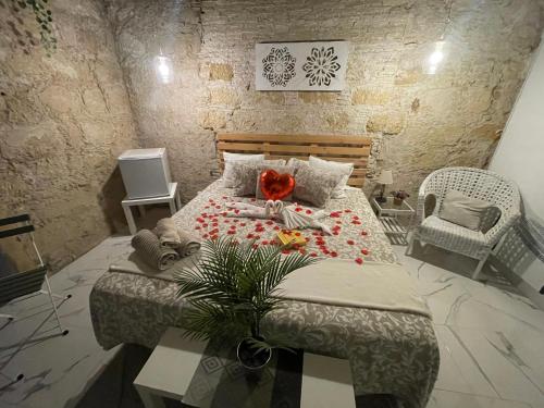 a bedroom with a large bed with flowers on it at BF BOUTIQUE JEREZ in Jerez de la Frontera
