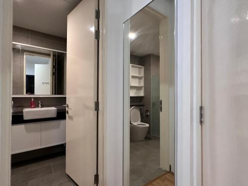 a bathroom with a toilet and a sink at New 2BR or 3BR Cozy Urban Suite Homestay at Georgetown8-10pax by URBAN STAYCATIONS LOD in Jelutong