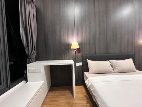 a small room with two beds and a table at New 2BR or 3BR Cozy Urban Suite Homestay at Georgetown8-10pax by URBAN STAYCATIONS LOD in Jelutong