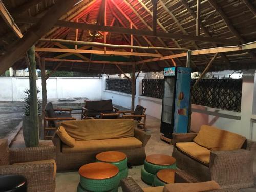 a living room with couches and chairs and a gas pump at Nana's Holiday Let in Accra