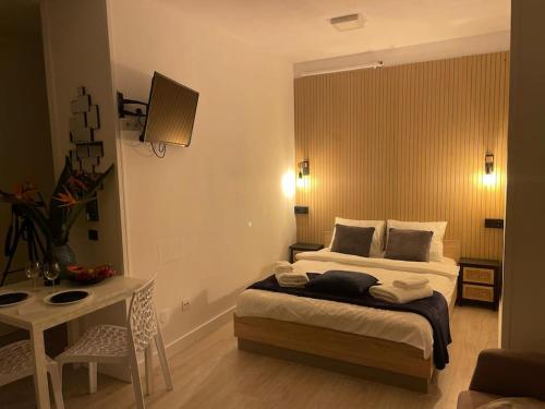 a bedroom with a bed and a table in it at A piece of paradise in Puerto de la Cruz in Puerto de la Cruz