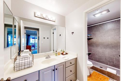 a bathroom with a sink and a toilet and a mirror at Solar Serenity in Flagstaff