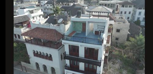 a white building with a gazebo on top of it at Pwani House - Lamu Seafront in Lamu