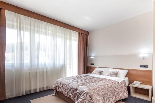 Postel nebo postele na pokoji v ubytování Hotel Macola