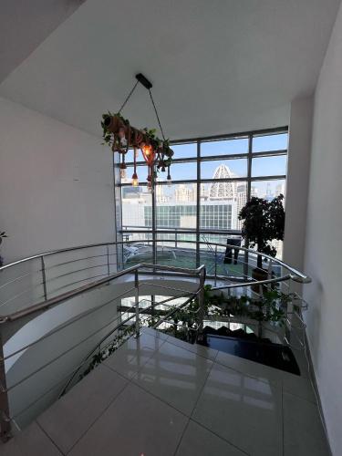 a balcony with a glass table in a building at ThePenthouse Coliving II in Dubai