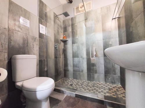 a bathroom with a toilet and a sink at Lagoon Cabanas in Ramsgate