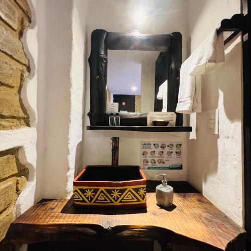 a bathroom with a sink and a mirror at Hotel Boutique Samay in Duitama