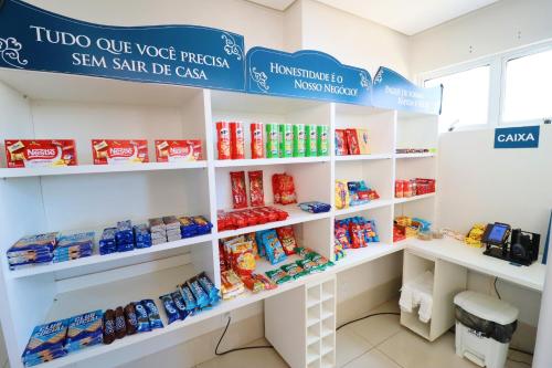 a store with white shelves filled with food at PALMAS EXPERIENCE - FLAT PÔR DO SOL, vista panorâmica, melhor localização in Palmas