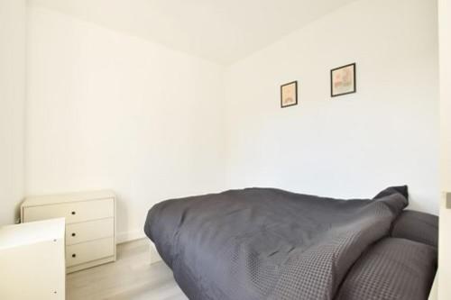 a white room with a bed and a dresser at 46 Havelock Street in Kettering