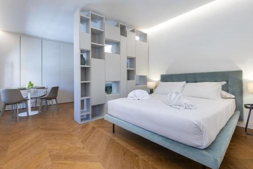 a bedroom with a large white bed and a table at UNYCA - Duomo Luxury View Florence in Florence