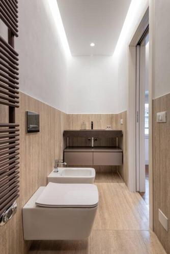 a bathroom with a white toilet and a sink at UNYCA - Duomo Luxury View Florence in Florence
