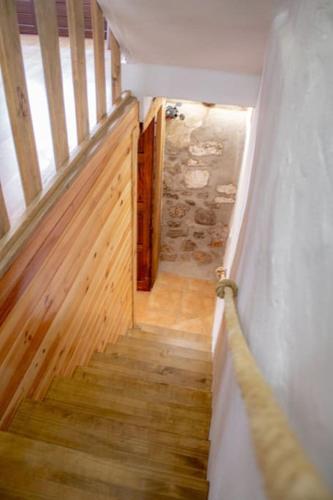 a staircase in a house with wooden floors and a door at La casa de la Golondrina in Pedro Bernardo