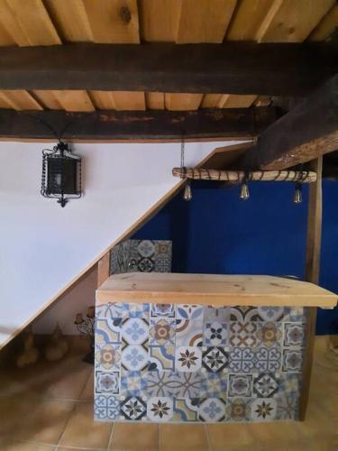 a room with a table with tiles on the floor at La casa de la Golondrina in Pedro Bernardo
