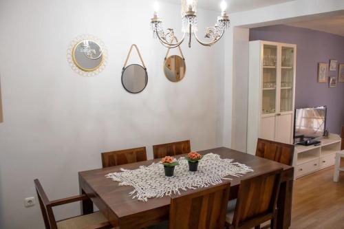 a dining room with a wooden table and chairs at La casa de la Golondrina in Pedro Bernardo